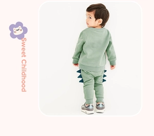 Detail view of little boys dinosaur fleece tracksuit with 3D spine patches on trousers