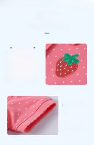 Detail of pink polka dot polo dress featuring strawberry embroidery and neat stitching
