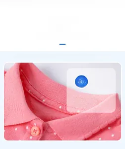Detail of pink polka dot polo collar and cotton knitted fabric on baby girl summer dress