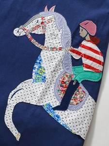 Short sleeve navy cotton dress for girls featuring a colorful patchwork horse rider applique