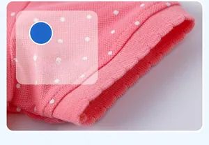 Detail of pink polka dot knit sleeve showing high-quality stitching and cotton fabric