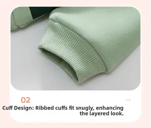 Close-up of ribbed cuffs on mint green kids sweatshirt with premium cotton texture