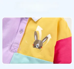 Detail of baby girl cotton dress showing breathable fabric and cute rabbit embroidery