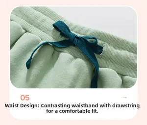 Detail of mint green fleece trousers with a contrasting dark blue drawstring waist