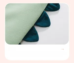 Detail shot of light green cotton kids pants featuring 3D blue fin-shaped ear accents