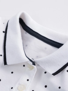 Short sleeve polo dress for girls featuring black polka dots and a contrast collar