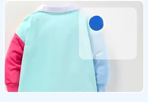 Detail view of cotton dress back with mint green, red, and blue color-block design