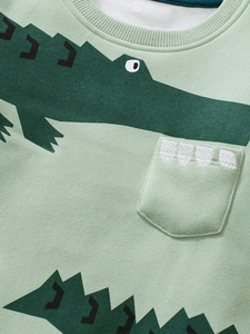 Kids long sleeve fleece top in light green with cute crocodile print and pocket detail