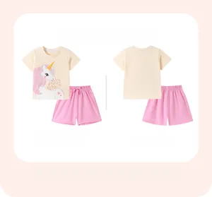 Detailed flat lay of girl's cotton summer set featuring unicorn tee and pink shorts