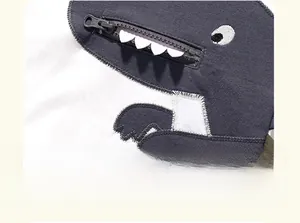 Close-up of children's cotton t-shirt with funny dinosaur embroidery and functional zipper