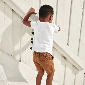 Boys summer cotton set featuring a white short sleeve dinosaur t-shirt and khaki shorts