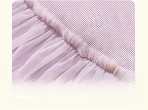 Detail of light purple dress with ribbed cotton bodice and rainbow embroidery on tulle