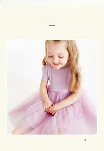Detail of lavender purple girl's dress with rainbow print and layered tulle tutu skirt