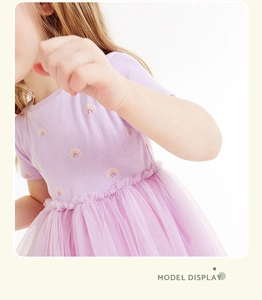 Detail of girls' purple rainbow cotton dress with a layered fluffy tulle tutu skirt