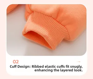 Detailed close-up of orange ribbed cuffs on kids sweatshirt showing elastic cotton texture