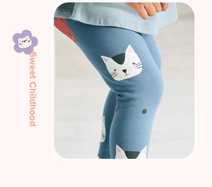 Detail of baby girl's blue leggings with cute cartoon cat and fish prints