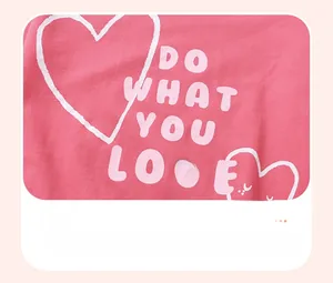 Detail of pink cotton sweatshirt featuring DO WHAT YOU LOVE graphic and heart design