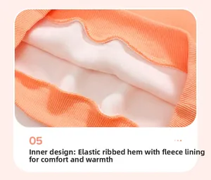 Detail view of orange fleece lining and elastic ribbed hem for warmth and comfort
