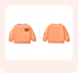 Detailed flat lay of girl's orange sweatshirt with tiger embroidery and leopard sleeves