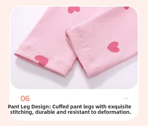 Close-up of pink ribbed knit toddler pants with red hearts and rolled cuff stitching