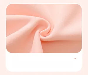 Detail shot of soft pink cotton knit fabric texture for girls fleece sweatshirt