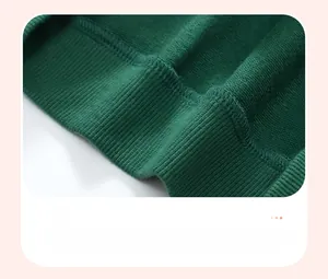Detailed close-up of dark green ribbed hem with reinforced stitching on cotton sweatshirt