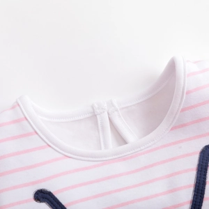 Close-up of pink striped cotton knit collar with button closure and refined stitching