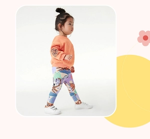Detail view of orange fleece sweatshirt with leopard patches and animal print leggings