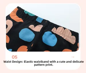 Macro view of elastic waistband on girls' black patterned trousers with discharge print