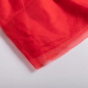 Detail of red fine mesh fabric with soft tulle texture for children's winter dresses
