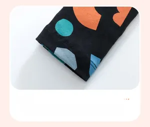 Detail of child joggers featuring colorful geometric prints and double-stitch leg cuffs