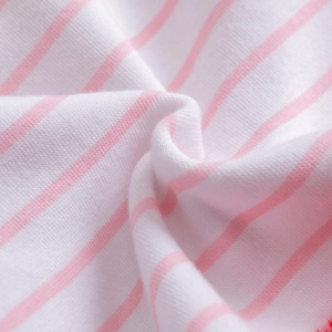 Detailed macro view of soft pink and white striped fleece knit fabric for girls' dresses