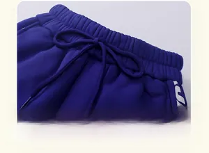 Detail view of navy blue kids' thermal trousers with elastic waistband and drawstring