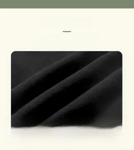 Detailed close-up of soft black knit cotton fabric texture for warm winter children trousers