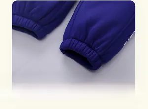 Detailed macro view of elastic ribbed cuffs on navy blue thermal joggers for boys