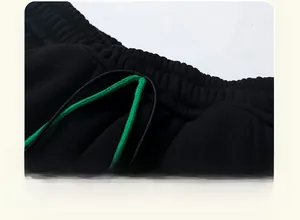 Detail of children's thick thermal pants with elastic waistband and green drawstring