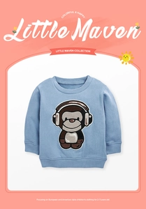 Detail of embroidered cartoon monkey patch on light blue fleece sweatshirt for kids