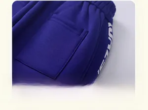 Detailed close-up of dark blue kids fleece joggers with elastic waist and pocket stitching