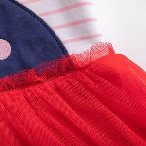 Detail of red tiered tulle skirt with navy polka dot fabric and striped cotton lining