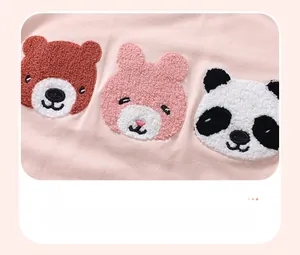 Detail of soft pink cotton sweatshirt showing thick towel embroidered cartoon animals