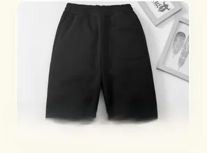 Detail view of boys thick fleece-lined winter trousers featuring an elastic waist and back pocket