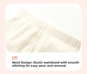 Dettaglio della vita elastica a coste con cuciture di precisione sul completo bianco panna
