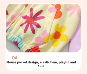Detail of girls' yellow hoodie with colorful daisy print and front kangaroo pocket