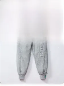Detail of grey fleece-lined kids' joggers with green drawstring and embossed leg lettering