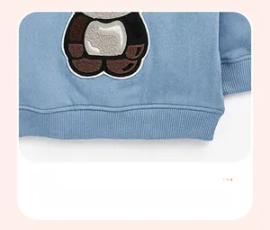 Close-up of baby sweatshirt ribbed elastic hem with panda towel embroidery detail
