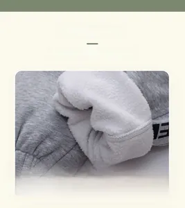 Close-up of gray knit fabric with thick white fleece lining and ribbed cuffs for boys