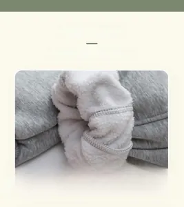 Detail of warm grey knit children's trousers with soft white fleece lining texture