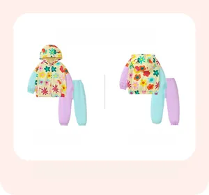 Detailed flat lay of girl's yellow floral hooded tracksuit jacket and matching trousers