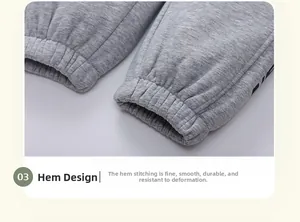 Detailed view of ribbed cuffs and letter print on fleece-lined grey children's joggers