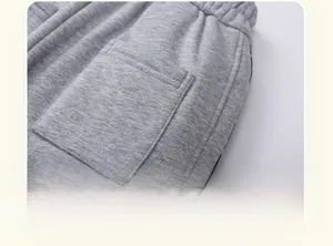 Detail of side pocket and reinforced stitching on gray fleece-lined children's trousers